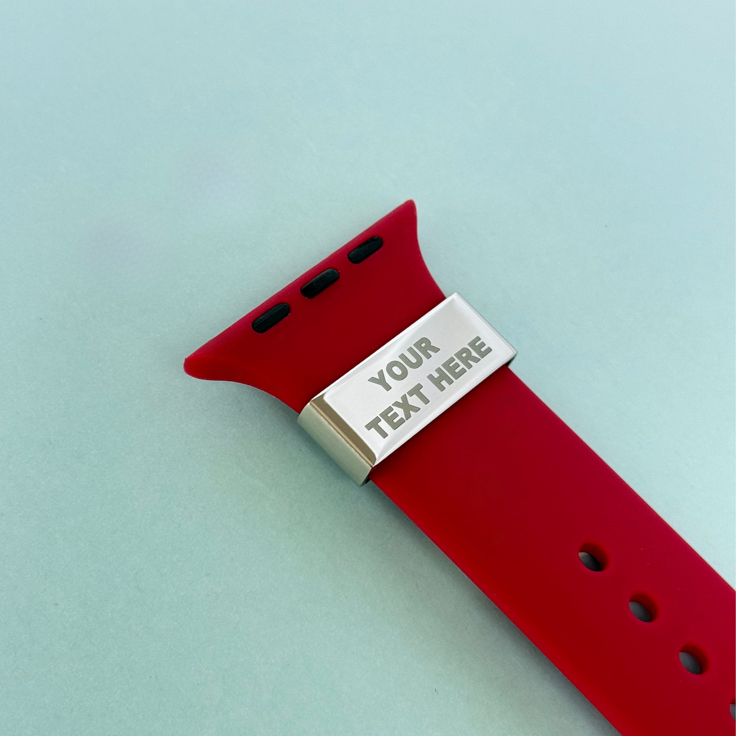 Personalised watch strap charm with 'Your Text Here' engraving on red band – custom tag for Apple, Garmin and Whoop watches