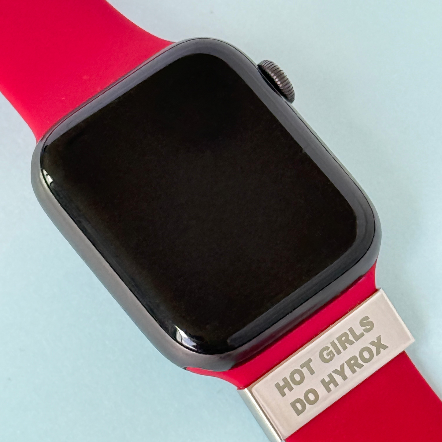 Soltag Apple Watch charm engraved with 'Hot Girls Do Hyrox' on a red strap, perfect for female HYROX athletes
