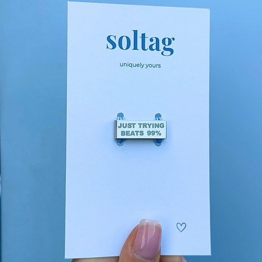 Engraved watch strap tag that says ‘Just trying beats 99%’ – custom Soltag packaging
