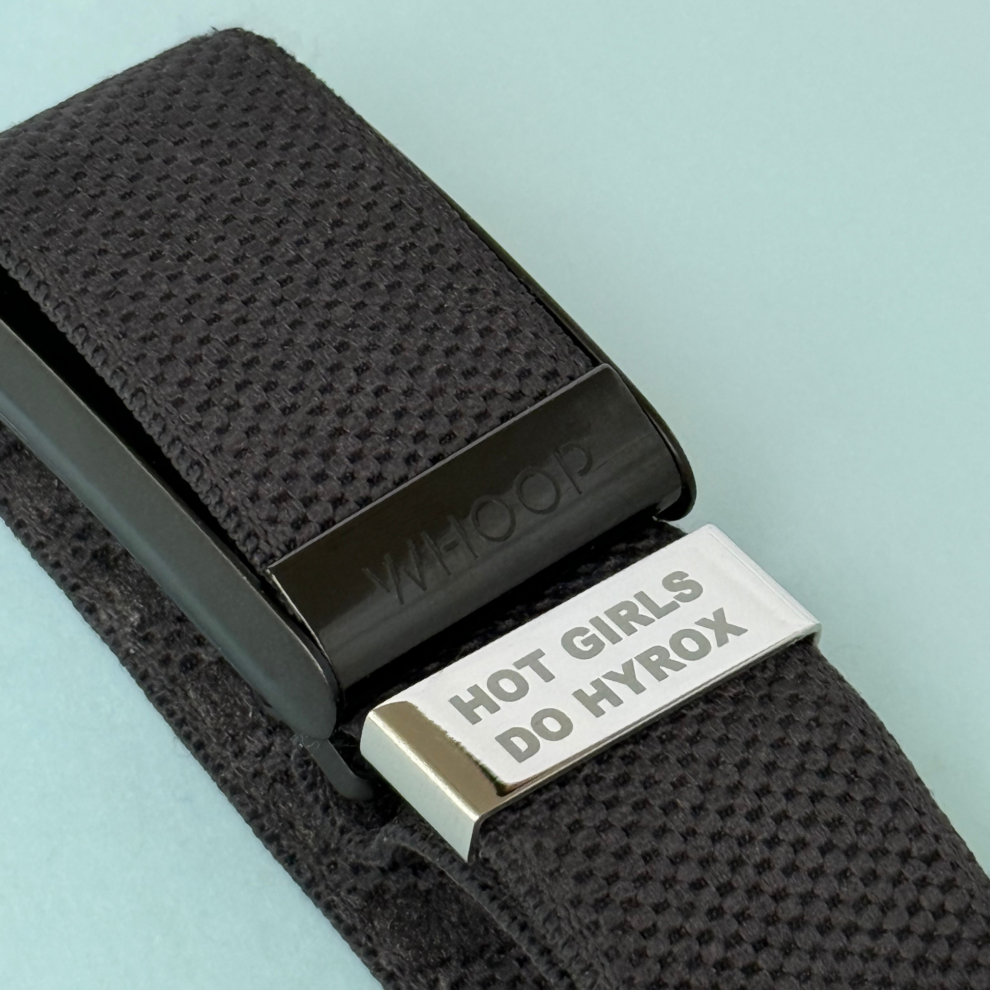 Motivational engraved watch tag that says 'Hot Girls Do Hyrox' on black Whoop strap – fits Apple, Garmin and Whoop devices