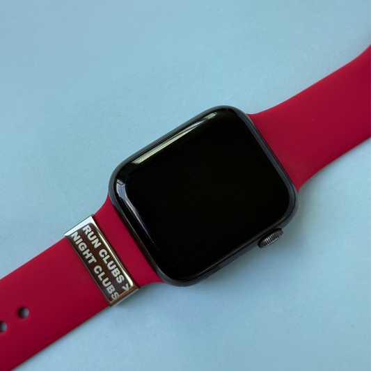 Front view of red Apple-style strap with engraved watch tag that says 'Run Clubs > Night Clubs' – motivational charm for Apple, Garmin and Whoop